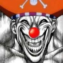 Clown face with a wide, manic grin and a bright red nose.