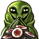 A green alien with a mischievous expression holding a stack of circular tokens with red floral patterns.