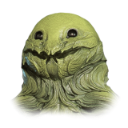 A green, textured creature with a wide, toothy grin and dark, round eyes.