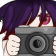 Anime character with purple hair peeking from behind a gray camera.