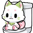 A white cat with pink and green accents sits on a toilet and blinks.