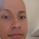 A person's face shown in a tight close-up with a suspicious and intense expression.