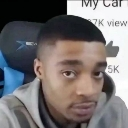 A man looking directly at the camera with a skeptical and unimpressed facial expression.