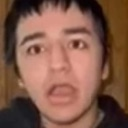 Person with a shocked expression and mouth wide open in a low-resolution photograph.