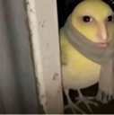 A yellow chick with a human face and a gray scarf peeking from behind a white doorframe.