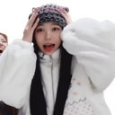 A girl wearing a patterned winter hat holds her hands to her head with a shocked, open-mouthed expression.