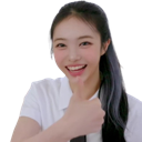 Young woman smiling and giving a thumbs up gesture.