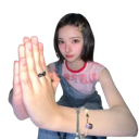 Young woman with short hair holding her hands together in a prayer gesture while looking at the camera.