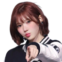 A young woman with short hair points her finger directly at the viewer with a confident look.