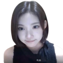 A young woman with short hair looking into the camera with a subtle, mischievous smirk.