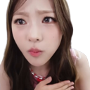 A young woman with long brown hair looking at the camera with a confused and suspicious expression.