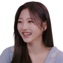 A young woman with long dark hair laughing with a joyful expression.