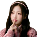 Young woman with a pink headband tapping her chin while looking skeptical.