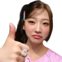 Young woman giving a thumbs up with a neutral and unimpressed facial expression.
