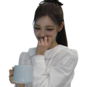 Young woman blushing and covering her mouth with her hand while holding a blue cup.