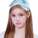 A young woman wearing a blue headband with a pouty, unimpressed facial expression.