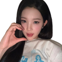 A young woman making a heart shape with her hand near her face.