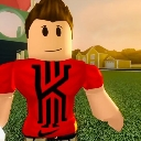A blocky 3D avatar wearing a red shirt standing on a grassy field.