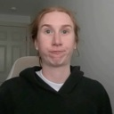 Person with red hair making a funny face with puffed-out cheeks.