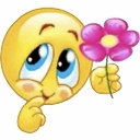 A yellow smiley face with large blue eyes looking up shyly while holding a pink flower.