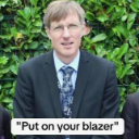 A man in a formal suit and tie with the text Put on your blazer overlaid on the image.
