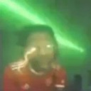 Person with glowing eyes and a green aura radiating power.