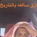 Man wearing a traditional headscarf holding his head in frustration with Arabic text overlay.