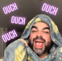 A man wrapped in a blanket shouting with the word OUCH floating around his head in purple text.
