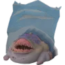 A pale, toothy creature with a wide mouth peeking out from underneath a blue blanket.