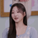 A young woman with long dark hair in a blue top is captured in a sequence of frames while clapping her hands.