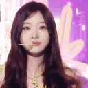 K-pop idol winking and forming a heart shape with her hands in a four-panel sequence.