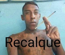 A man with a serious expression holds a cigarette while the word Recalque is written across his chest.