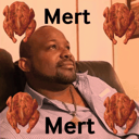 A man looking thoughtfully to the side surrounded by four roasted chickens.