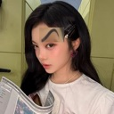 A woman holding a newspaper with an exaggeratedly large, drawn-on eyebrow looking at the camera with a skeptical expression.