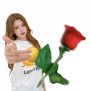 A young woman reaching forward while holding a single red rose.