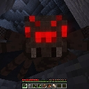 Minecraft spider with glowing red eyes staring from a dark cave.