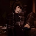 Roblox character wearing dark clothing with a simple smiling face.