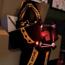 A dark, ornate coffin with glowing red lights and golden trim.