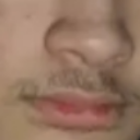 Mustache and lips in a close-up shot with an awkward, suspicious expression.