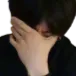Person covering their face with their hand in a gesture of disbelief.
