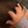 A hand repeatedly patting the top of a head in a gentle, rhythmic motion.