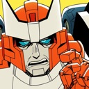 A robot with an orange and white head and blue eyes looks annoyed while pointing a finger forward.