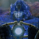 Robot with a blue metallic face and a glowing light in its chest looks confused.