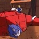 A red and blue robot lying face down on the ground in a deep sleep.