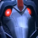 Robot face with glowing red eyes staring intensely forward.