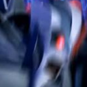 Robot face with a glowing red eye captured in intense motion blur.