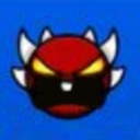 Demon face with red skin, sharp white horns, and glowing yellow eyes expressing intense rage.