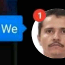 A man with a mustache stares forward with a red notification badge in the corner.