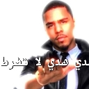 J. Cole holding his hand out in a stop gesture with a serious expression.