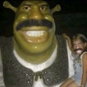 Shrek statue with a large mustache next to a person wearing a matching mustache filter.